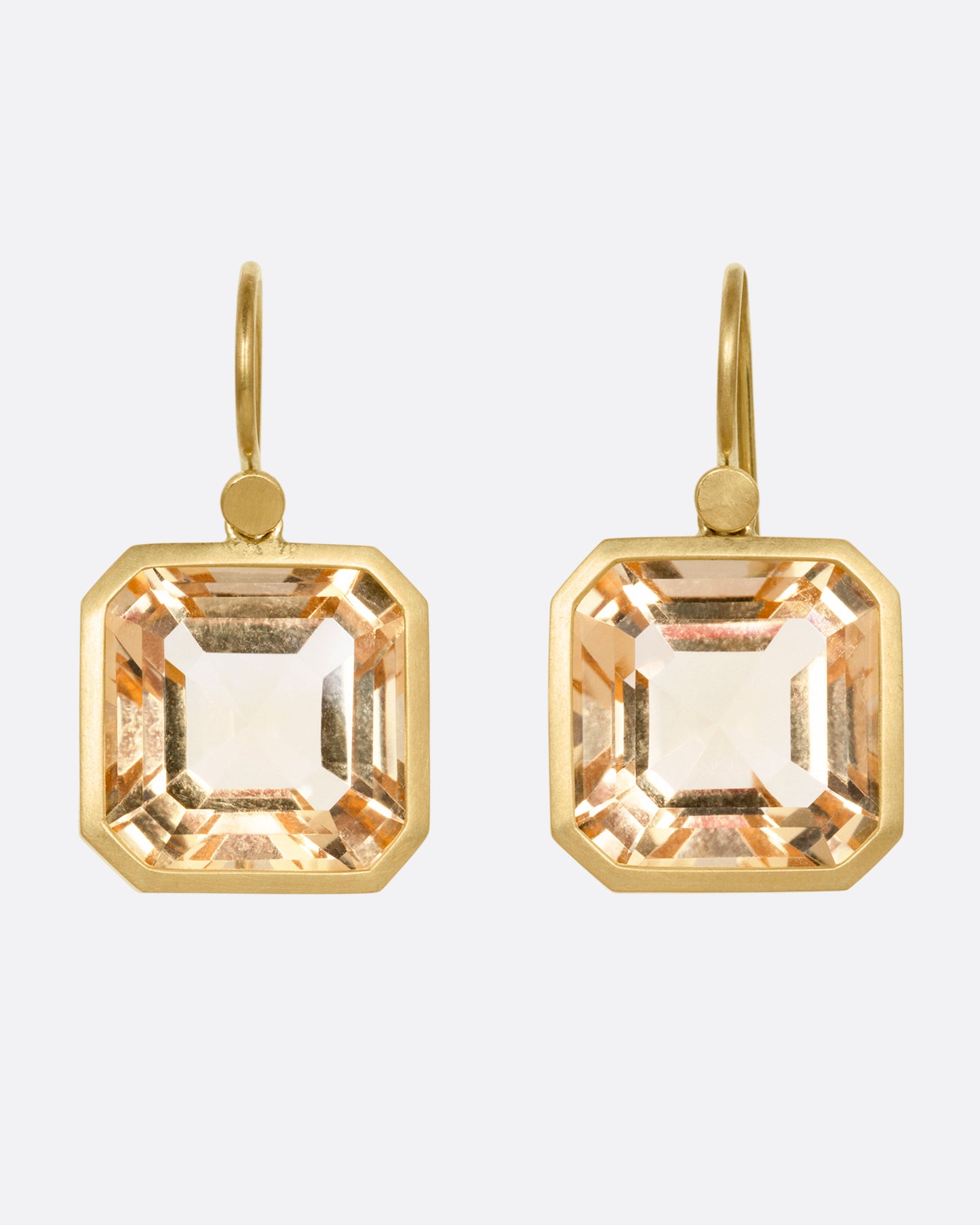 A pair of yellow gold drop earrings with octagonal citrines, shown from the front.
