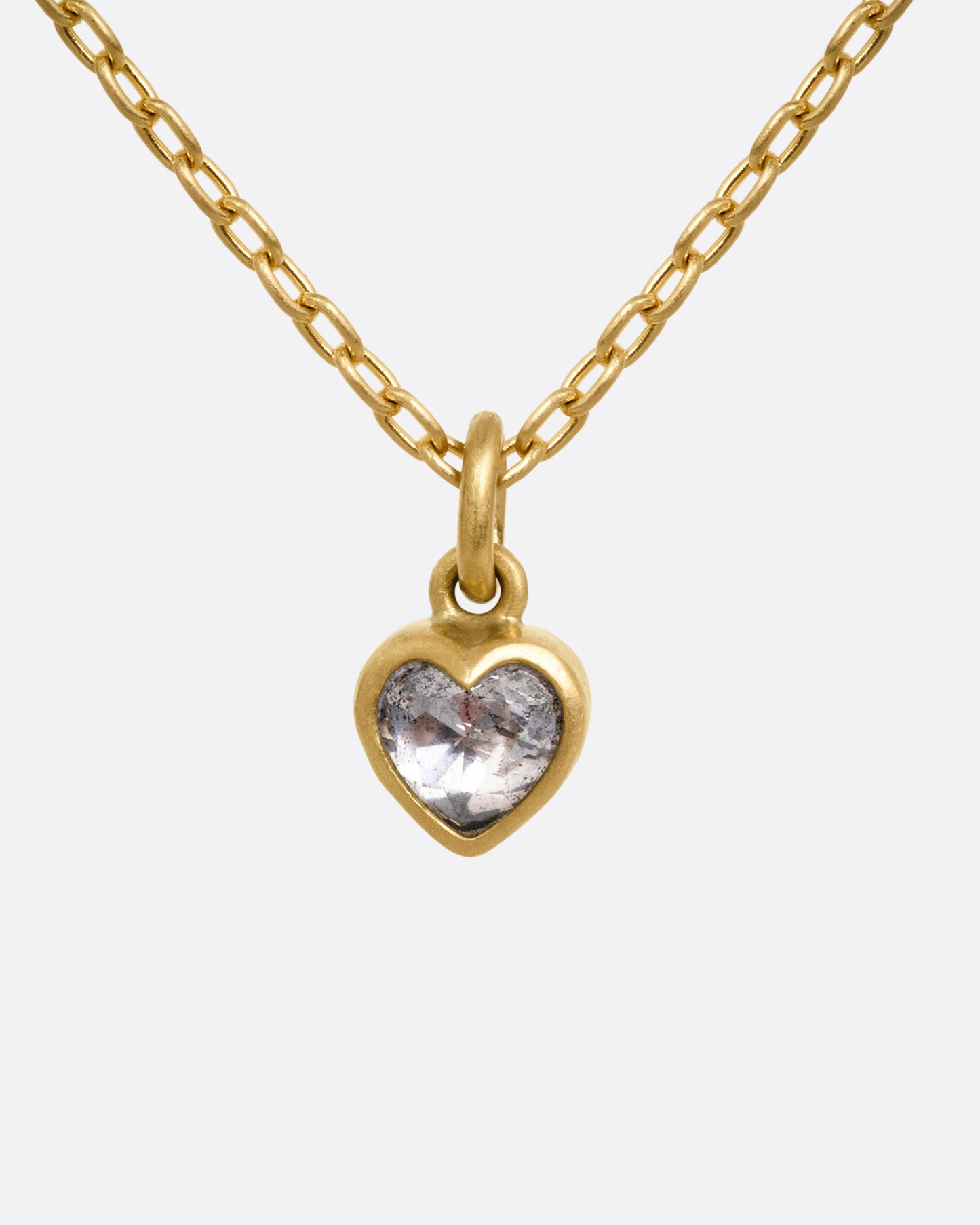 A yellow gold cable chain necklace with a dimensional diamond heart pendant, shown from the front.