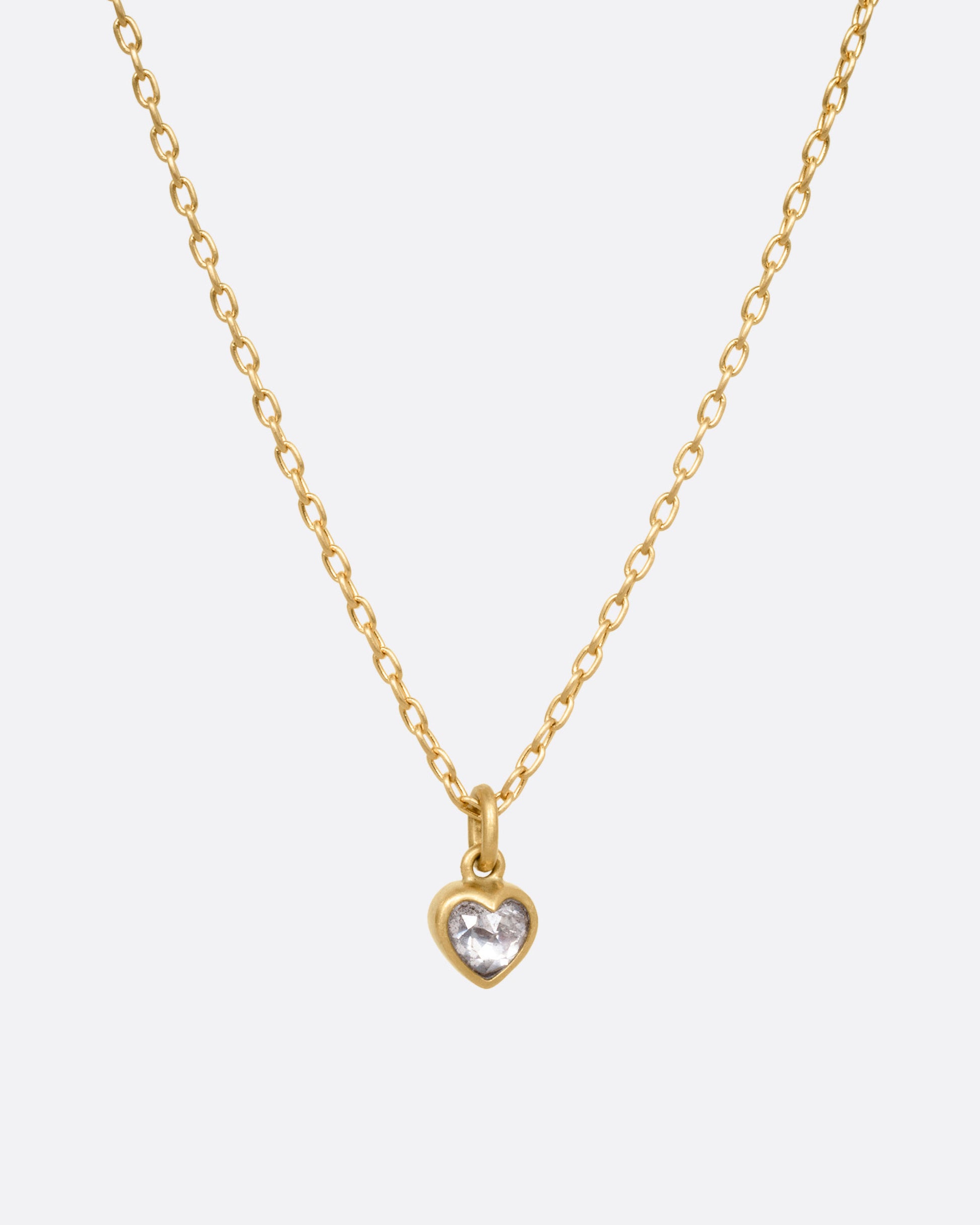 A yellow gold cable chain necklace with a dimensional diamond heart pendant, shown from the front.