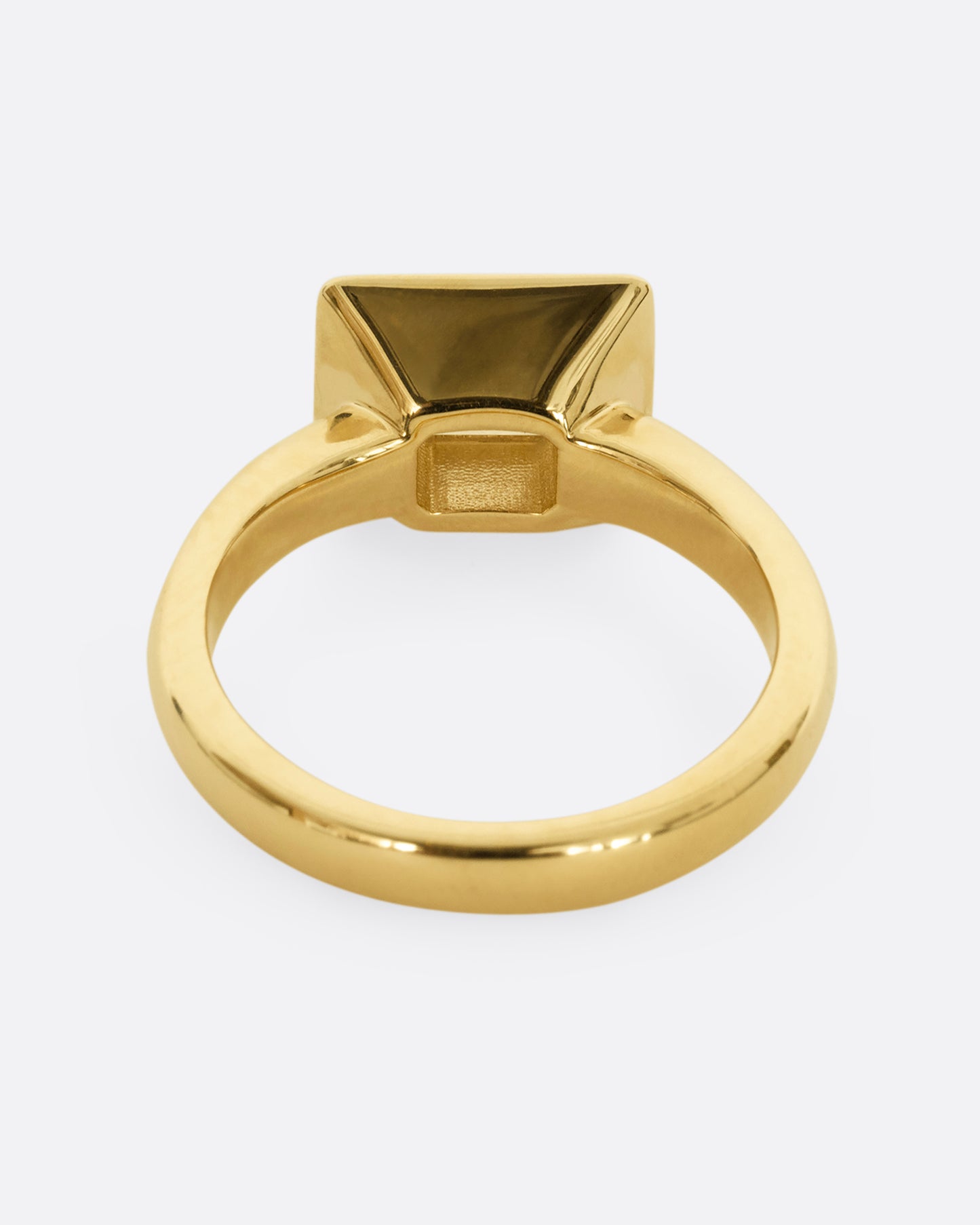 A yellow gold ring with an emerald cut diamond in a blue enamel striped rectangular setting. Shown from the back.