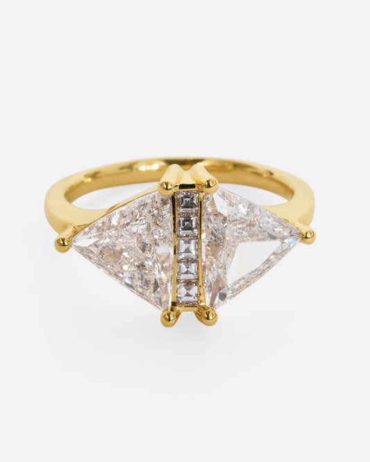 A yellow gold ring with two salt and pepper trillion cut diamonds and diamond accents. Shown from the front.