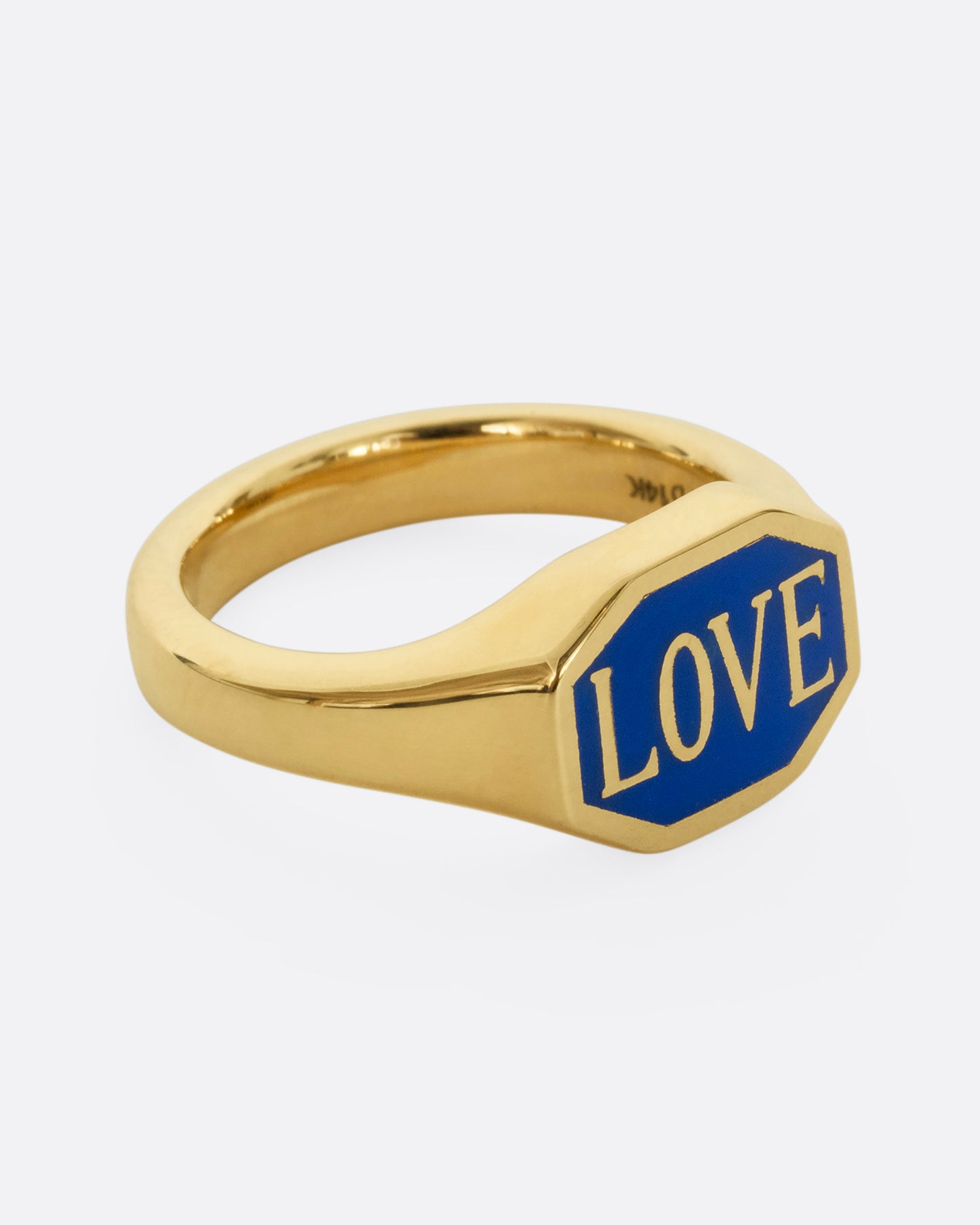 A yellow gold signet ring with blue enameled face with the word "Love". Shown from the alternate side.