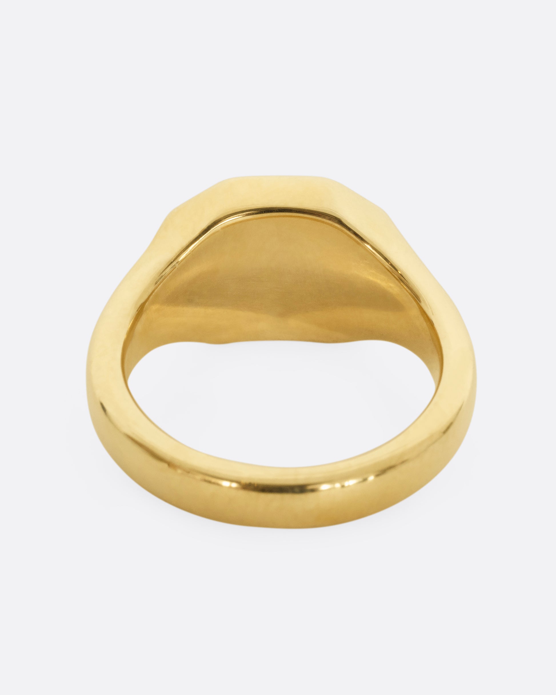 A yellow gold signet ring with blue enameled face with the word "Love". Shown from the back.