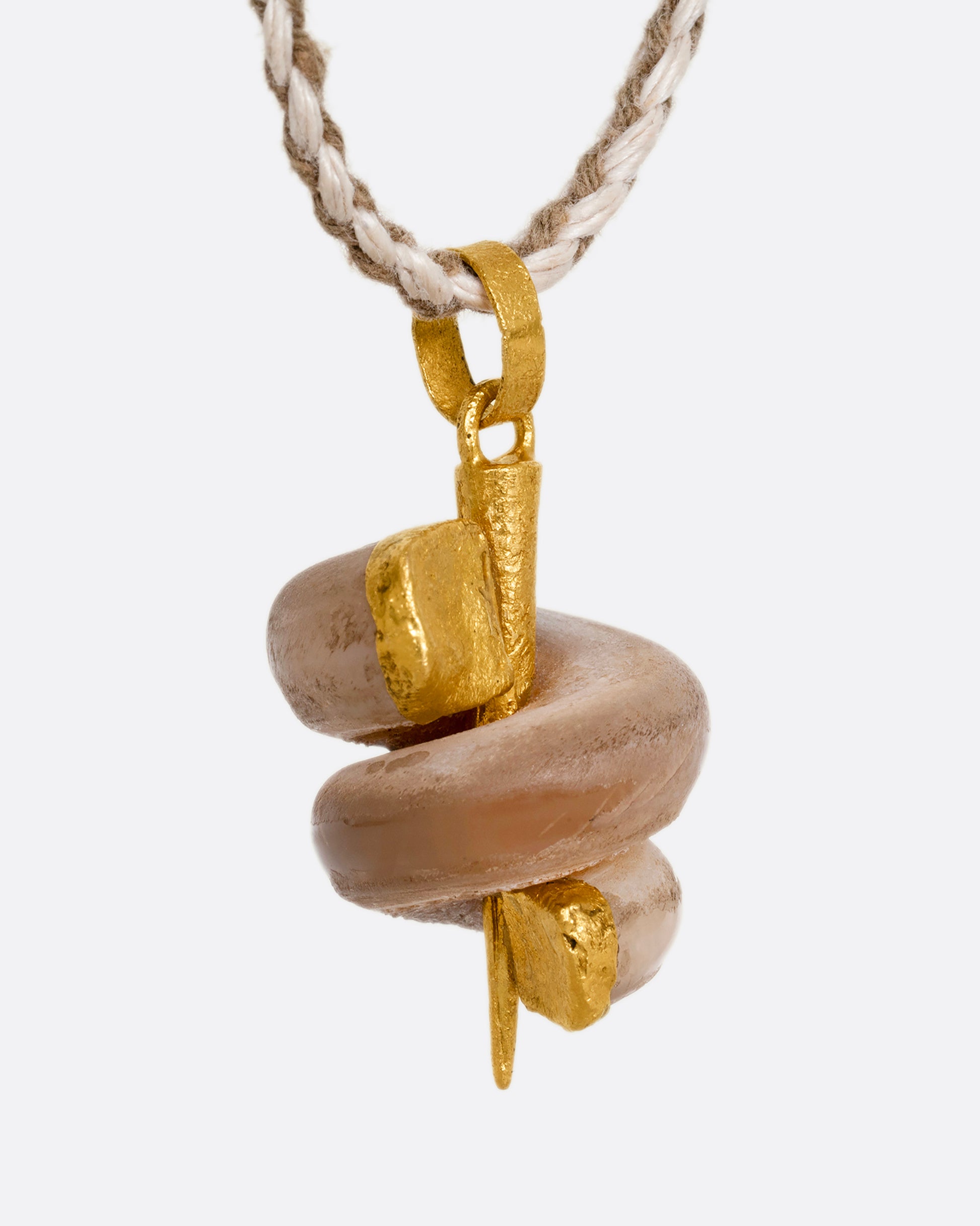 A high karat yellow gold necklace with an agate twist on a cord. Shown from the side.