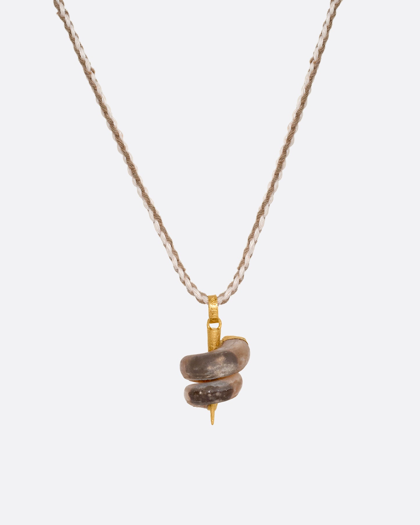 A high karat yellow gold necklace with an agate twist on a cord. Shown from the front.