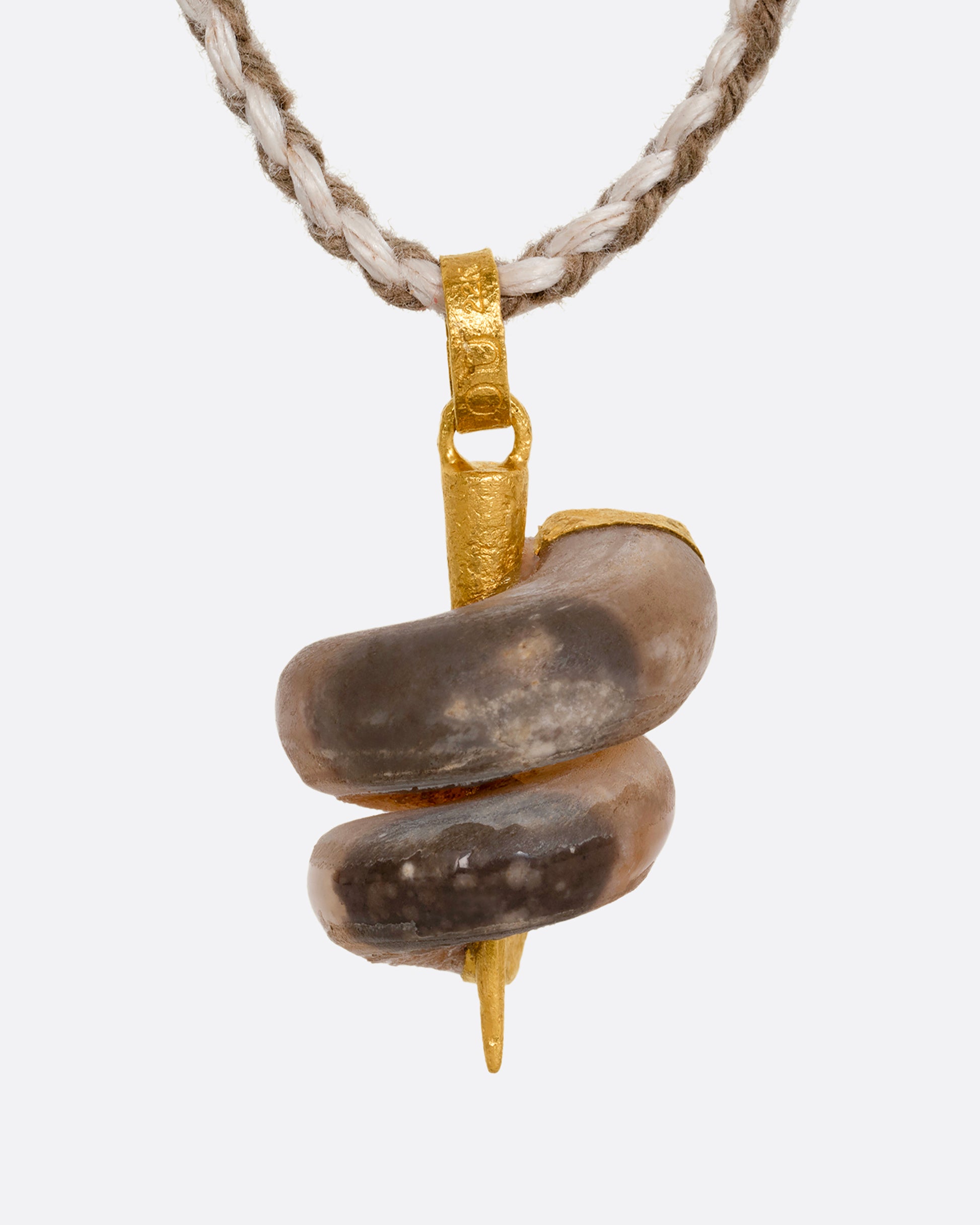 A high karat yellow gold necklace with an agate twist on a cord. Shown from the front.