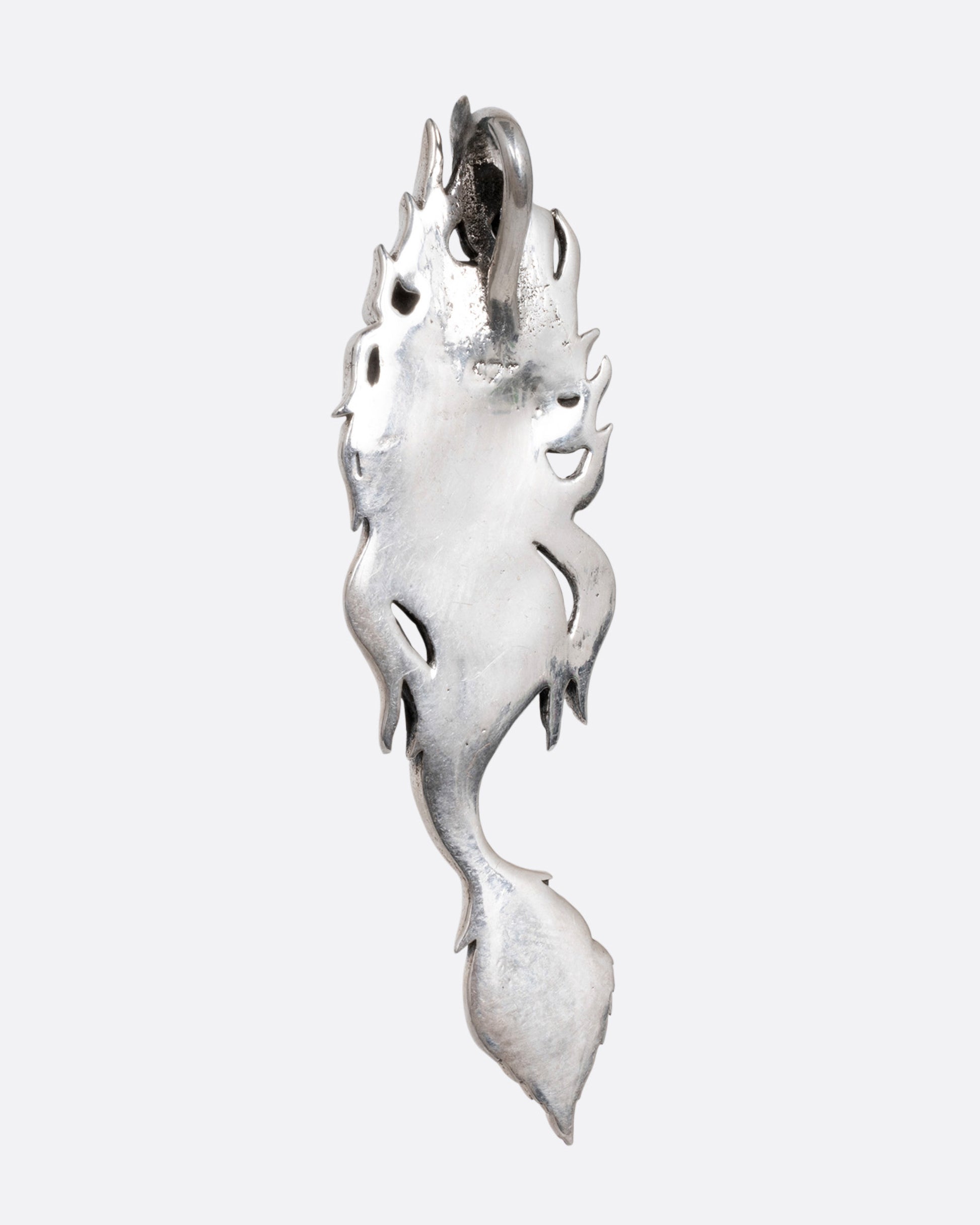 A silver mermaid pendant with abalone inlay on her tail, shown from the back.