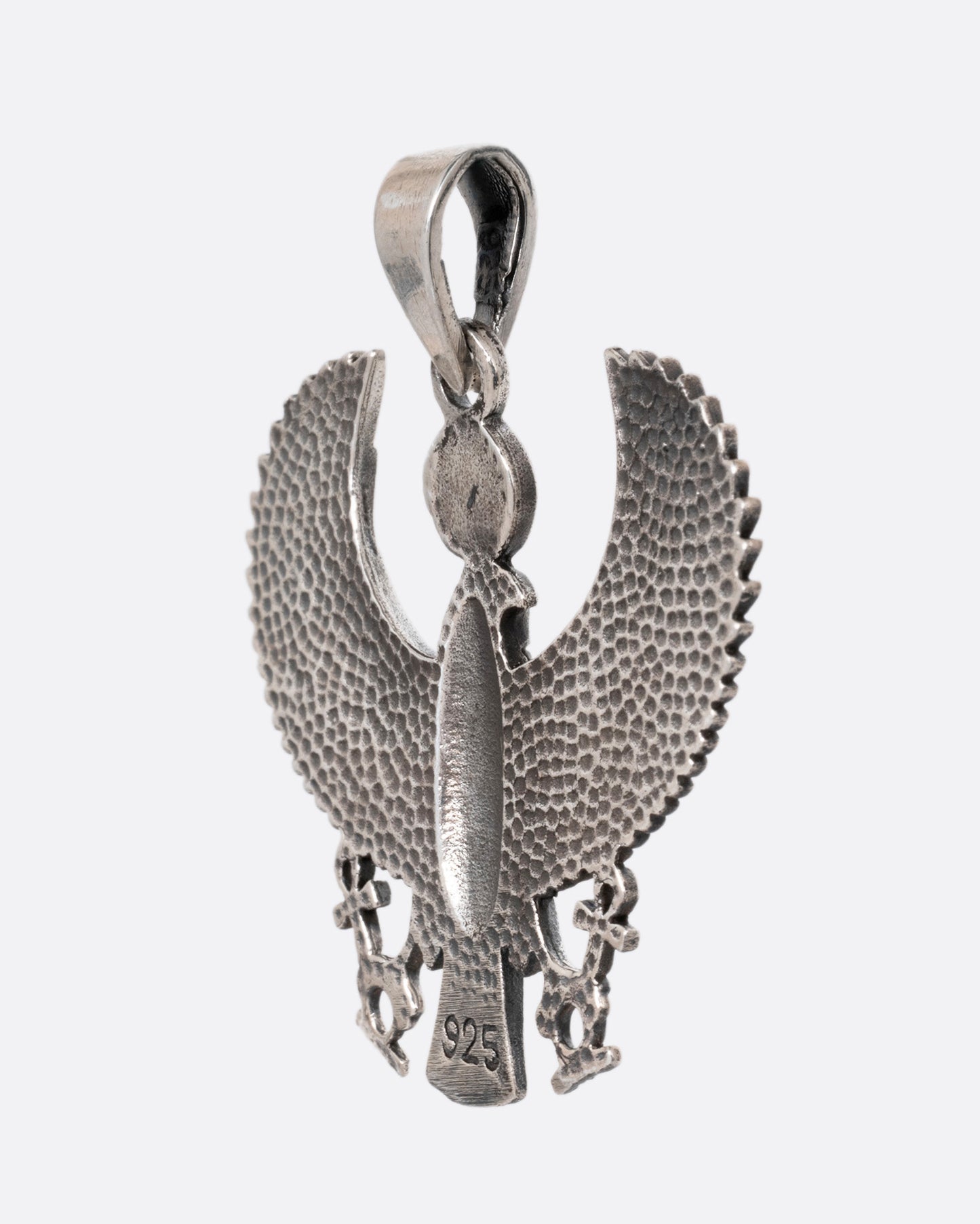 A silver pendant depicting the ancient Egyptian god, Horus, in falcon form, shown from the back. 
