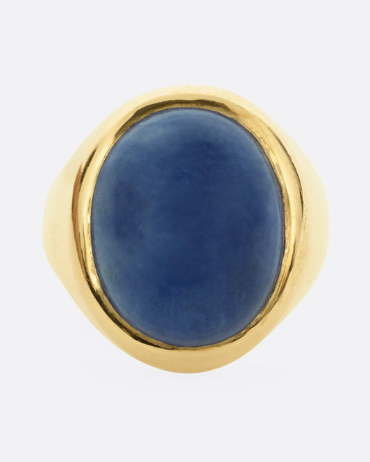 A yellow gold signet ring with a lapis cabochon, shown from the front.