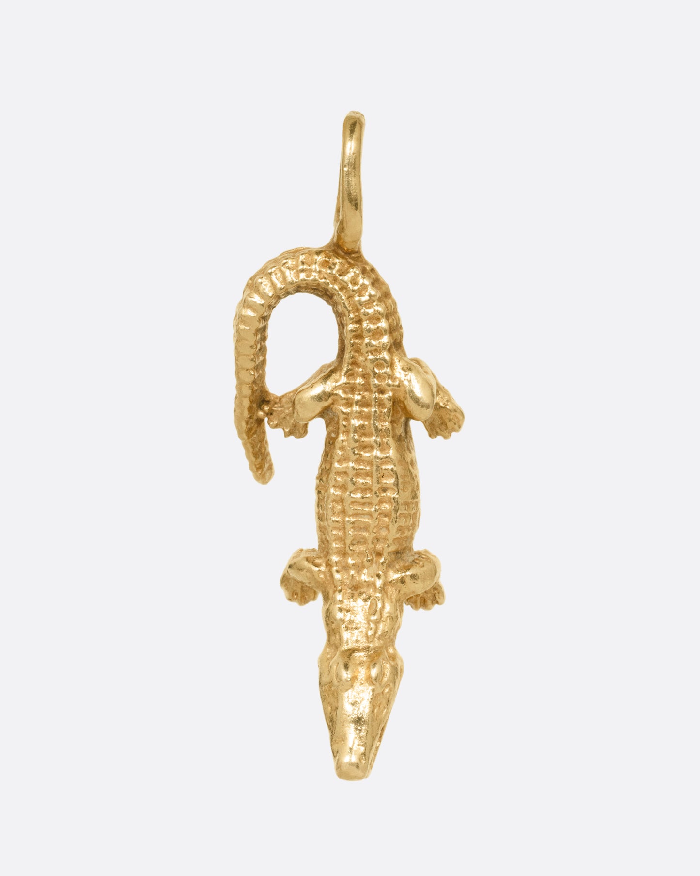 A yellow gold alligator charm, shown from the front.