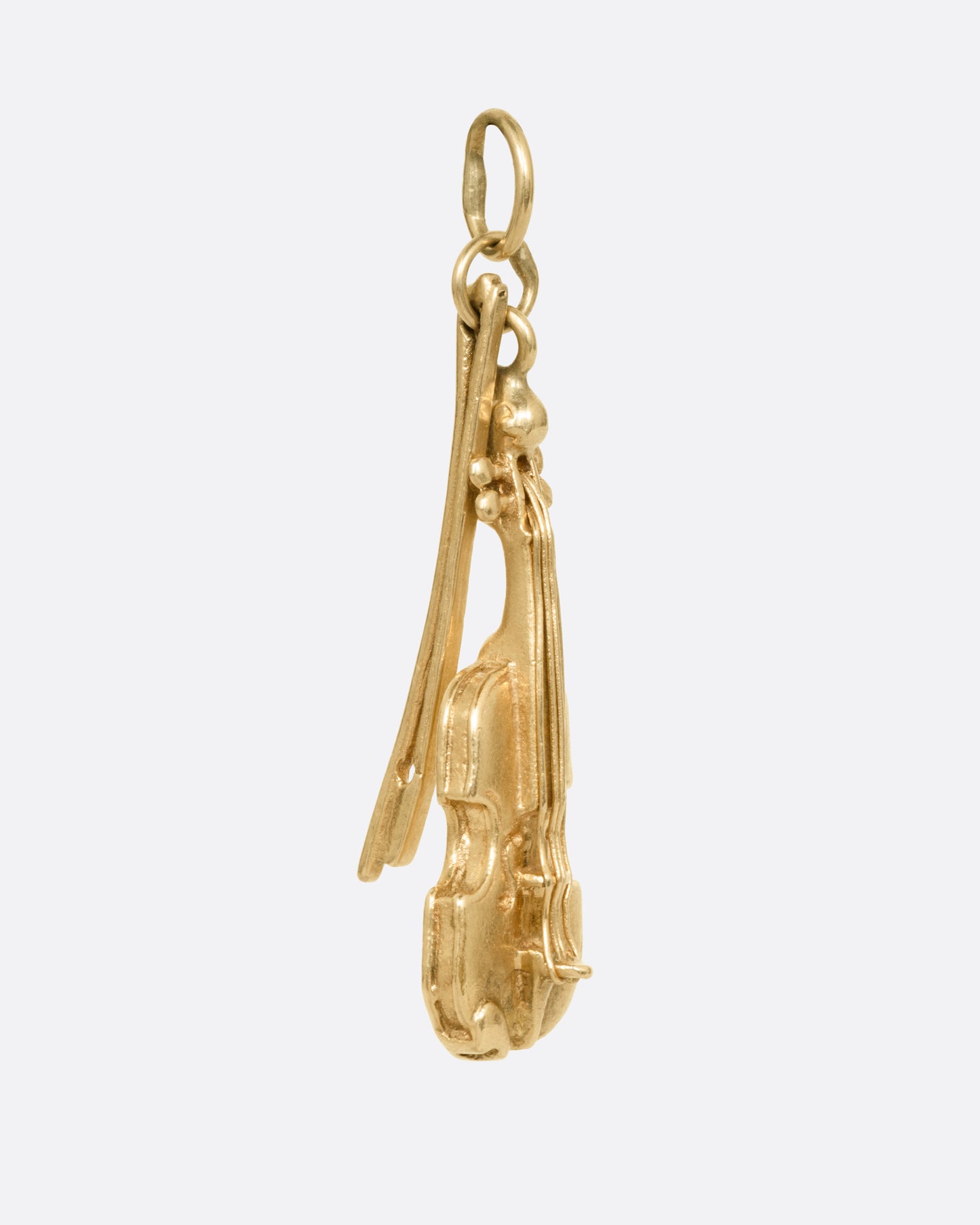 A yellow gold violin and bow charm, shown from the side.