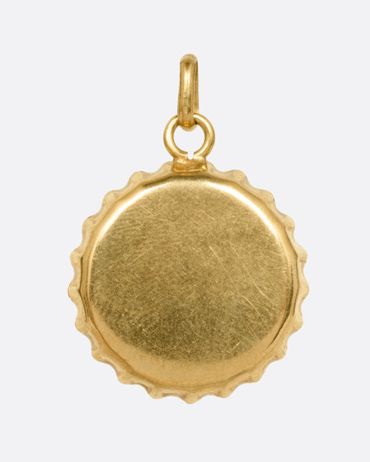 A yellow gold bottle cap charm, shown from the front.