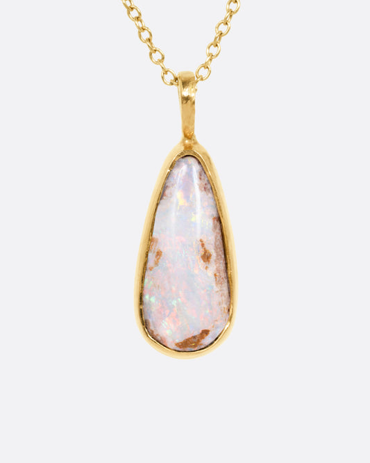 A yellow gold cable chain necklace with a teardrop shaped Australian opal pendant. Shown from the front.