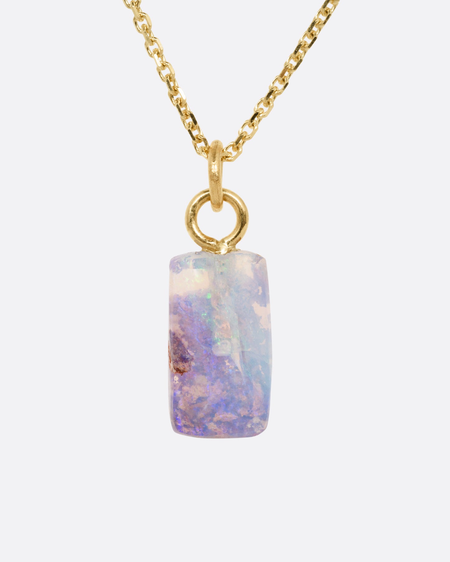 A yellow gold cable chain necklace with a fossilized Australian opal pendant. Shown from the front.