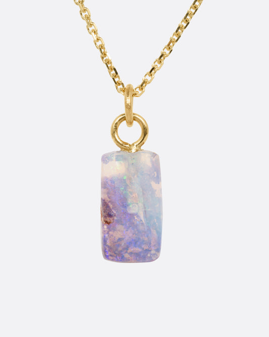 A yellow gold cable chain necklace with a fossilized Australian opal pendant. Shown from the front.