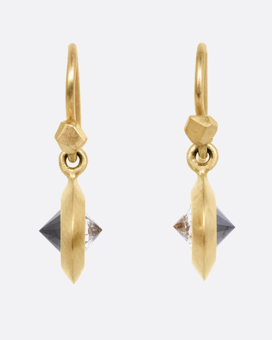 A pair of yellow gold drop earrings, each with reverse set black and gray diamonds. Shown from the front.