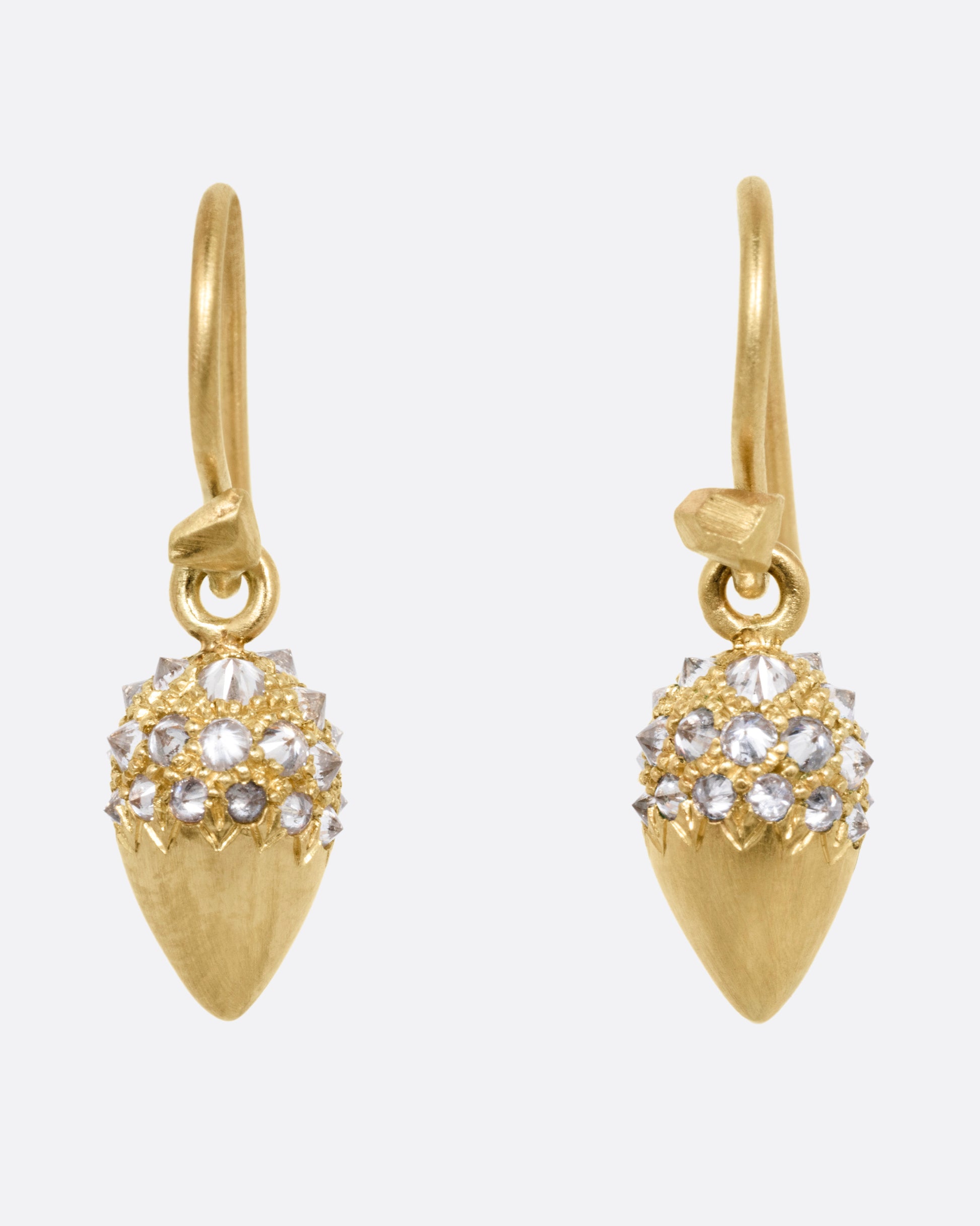 A pair of yellow gold drop earrings with reverse set diamonds on the top half. Shown from the front.