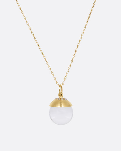 Yellow gold quartz sphere pendant necklace, the pendant hanging from its fine chain