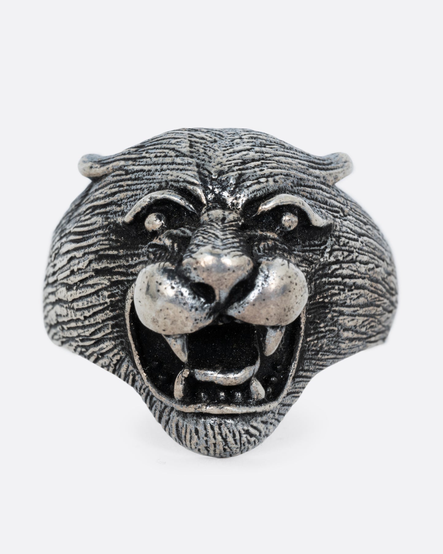A sterling cougar head ring, shown from the front.