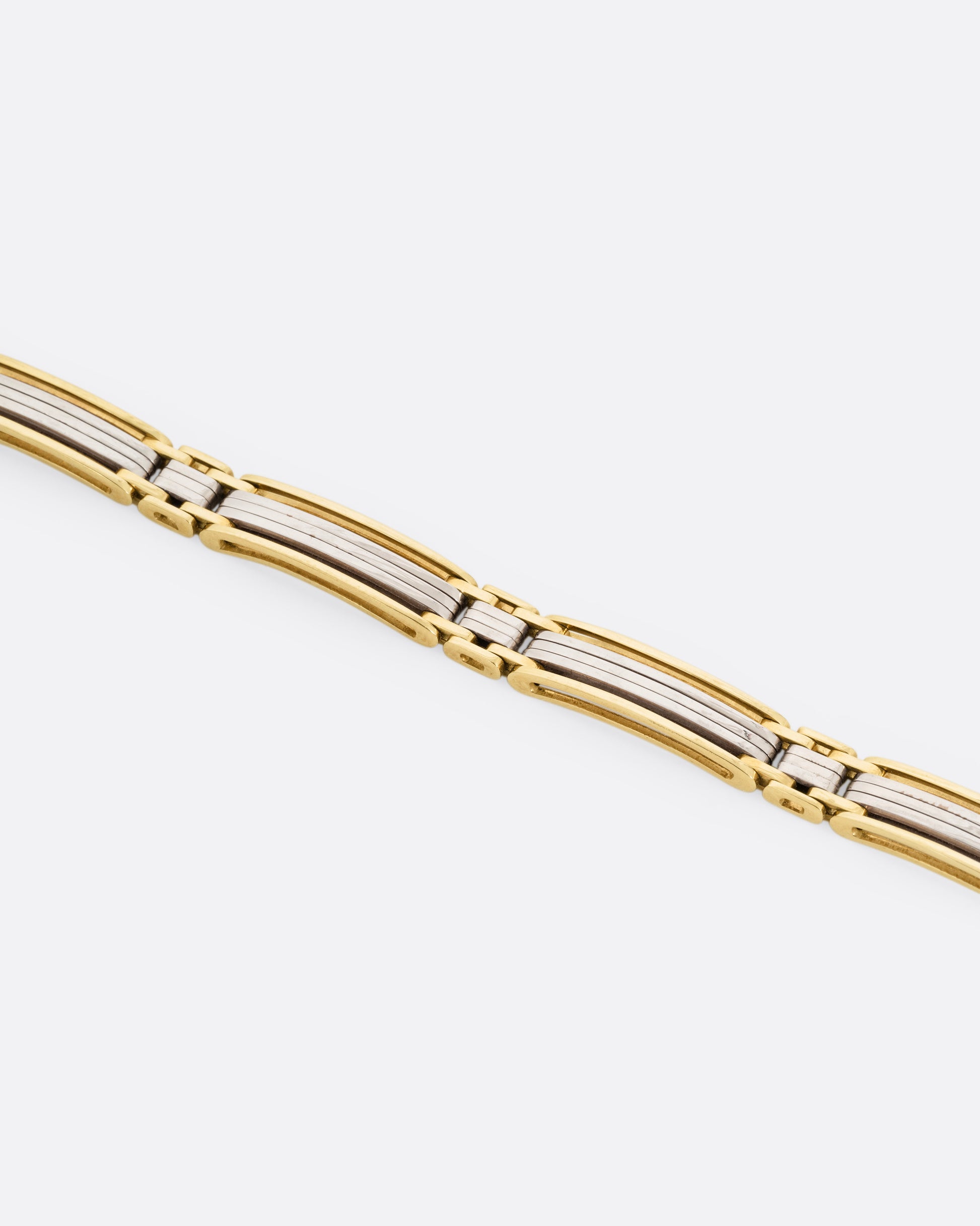 A yellow and white gold link bracelet, shown from the front.