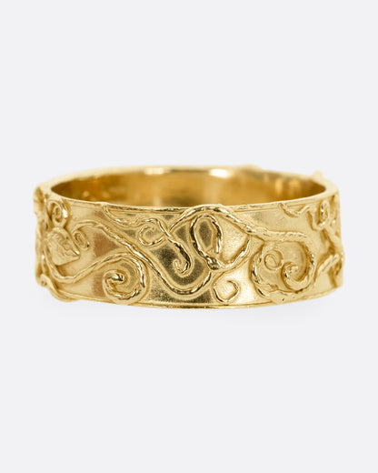 Evangeline Revelation band in 14k yellow gold, a wide band with raised filigree swirls