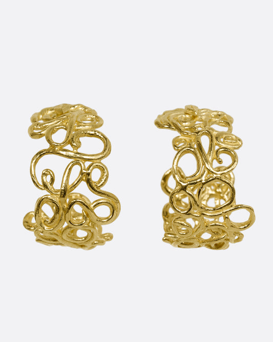 yellow gold swirl hoop earrings shown from the front