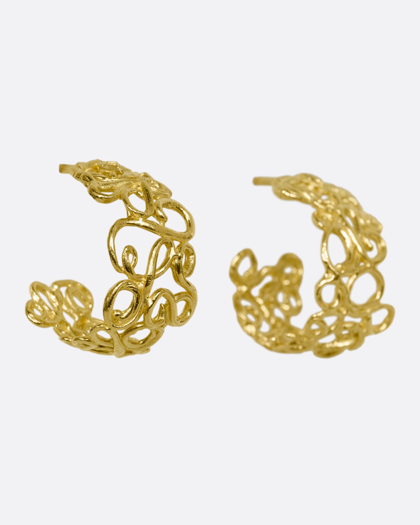 yellow gold swirl hoop earrings shown from the side