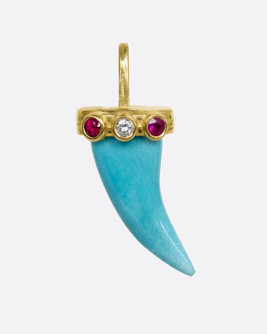 yellow gold tooth shaped turquoise charm with rubies and diamond shown from the front