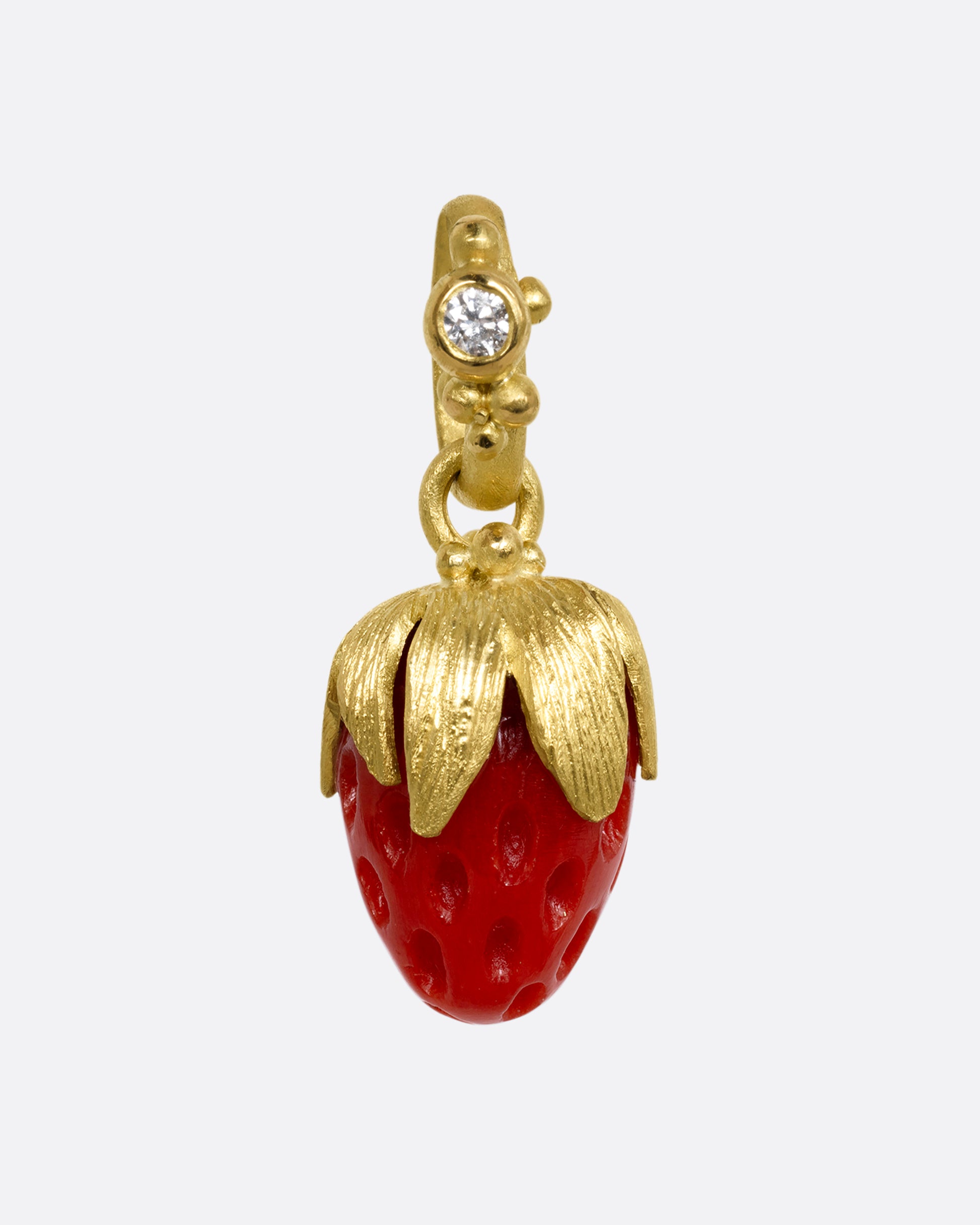 yellow gold charm with diamond and strawberry shaped coral shown from the front