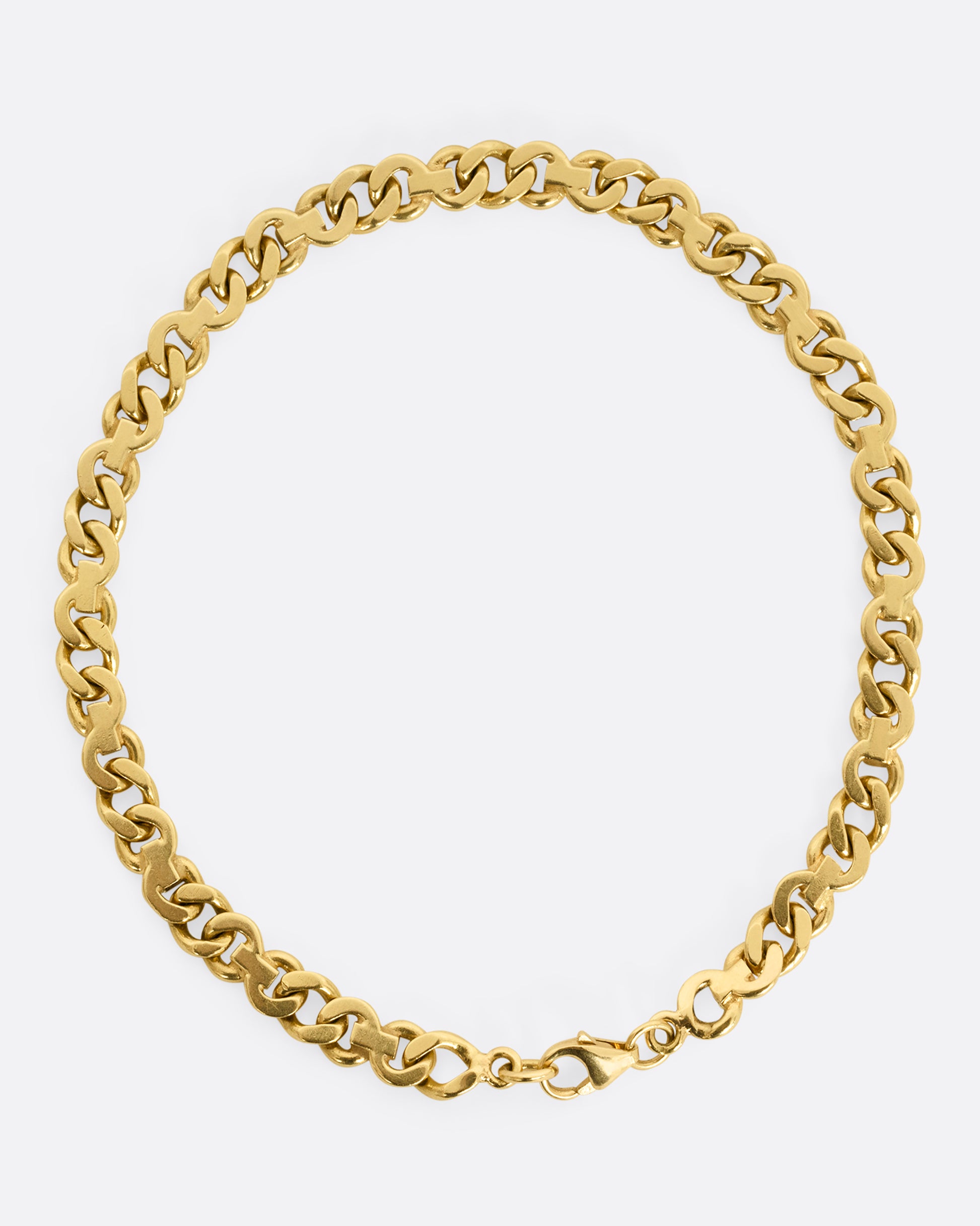 A mixed link yellow gold bracelet. Shown closed, from above.