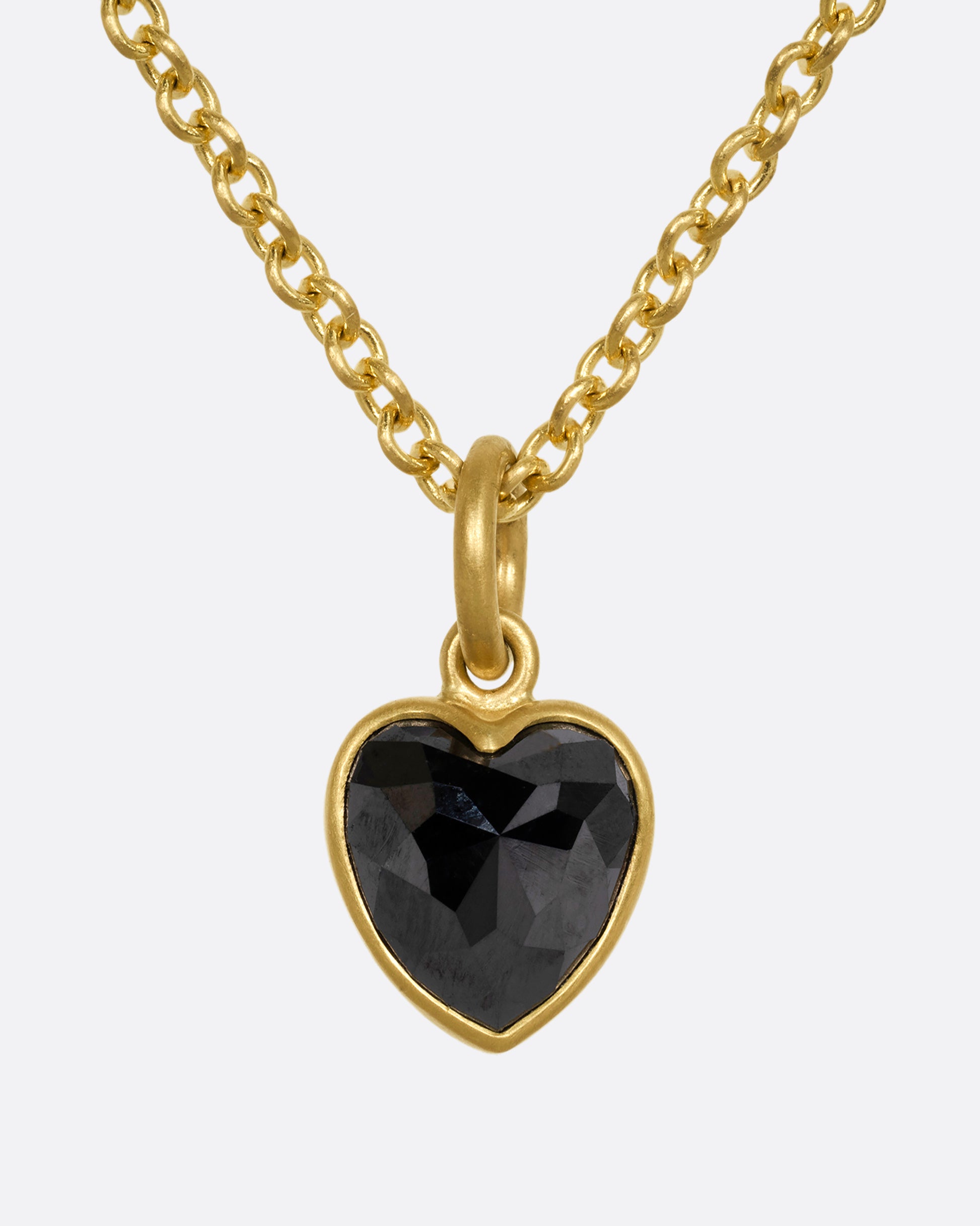 yellow gold necklace with heart shaped black diamond shown from the front