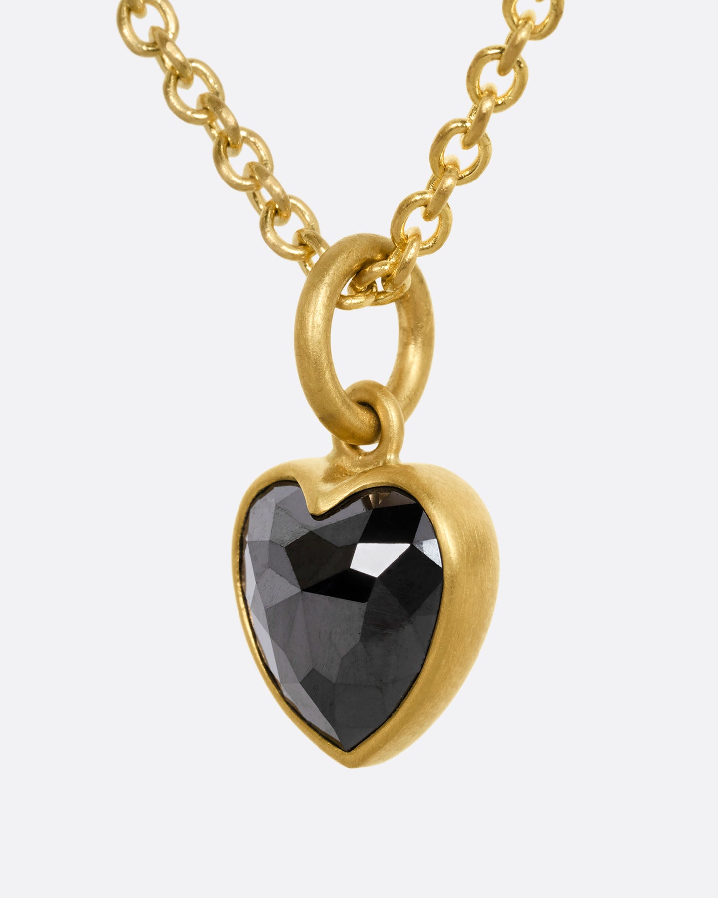 yellow gold necklace with heart shaped black diamond shown from the side