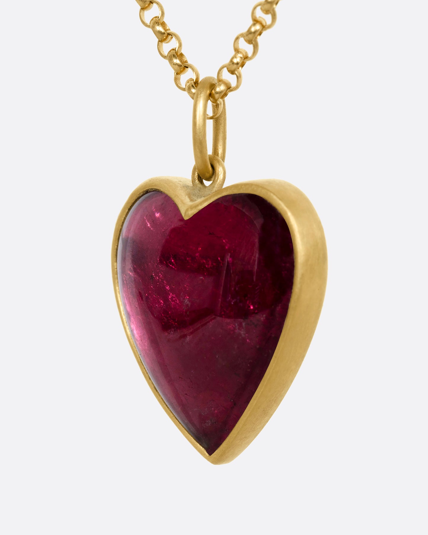 yellow gold necklace with a heart shaped tourmaline shown from the side