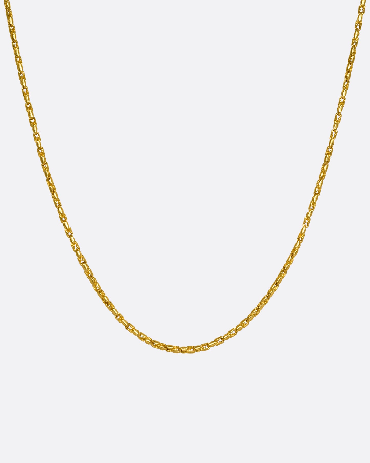 A high karat yellow gold Thai bhat chain. Shown hanging from the front.