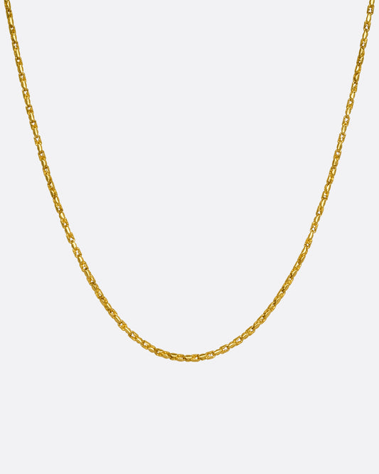 A high karat yellow gold Thai bhat chain. Shown hanging from the front.