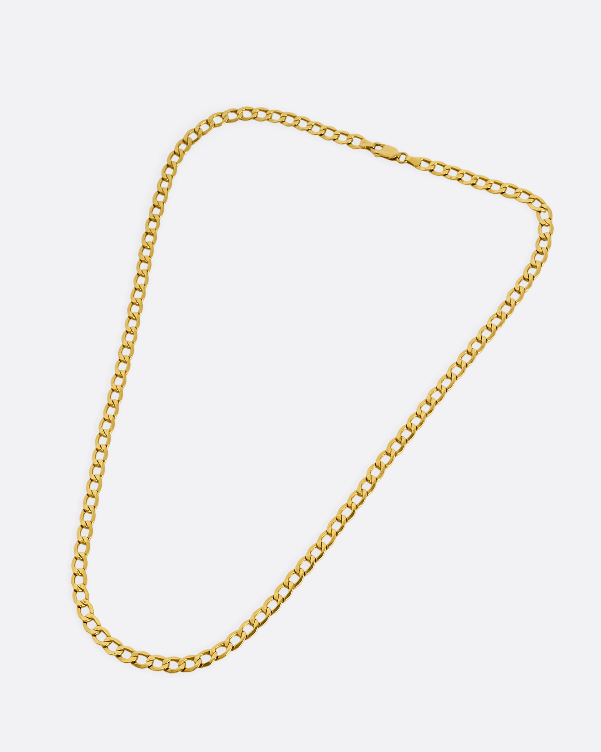 A high karat yellow gold Thai bhat chain. Shown laying flat.