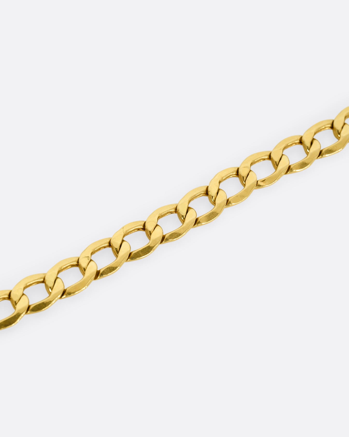 A high karat yellow gold Thai bhat chain. Shown close up on the links.