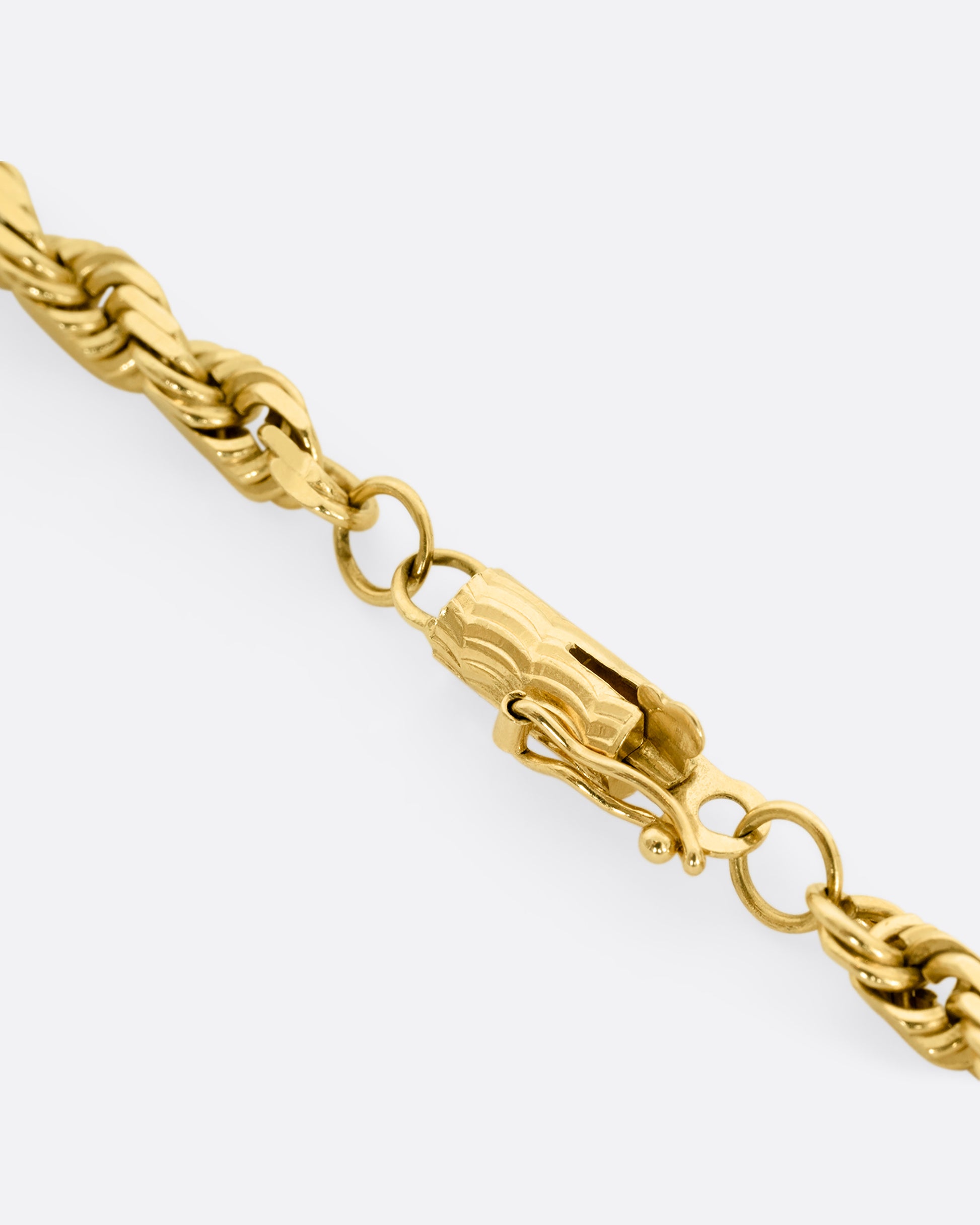 A yellow gold twisted rope chain. The clasp shown up close.