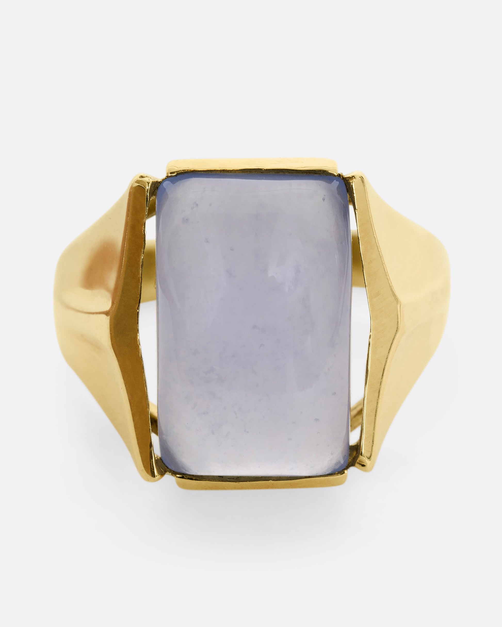 A yellow gold ring with a rectangular chalcedony face. Shown from the front.