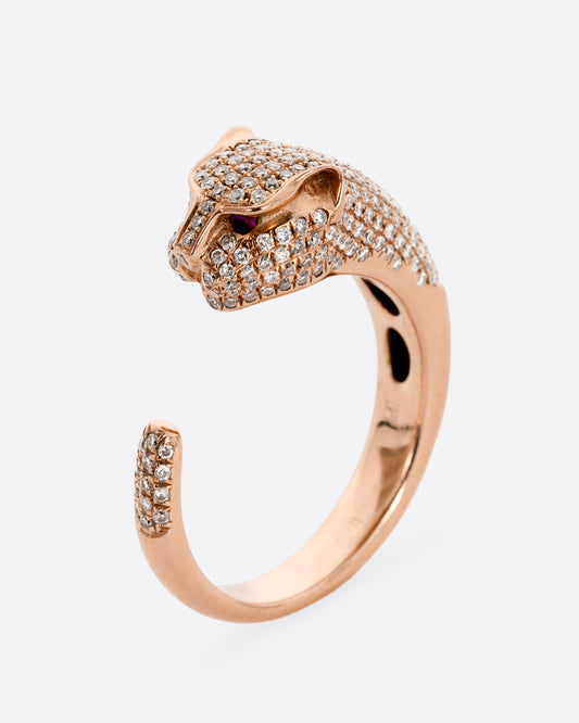 A rose gold panther wrap ring with pave diamonds on the head and tail and ruby eyes. Shown from the side standing up.