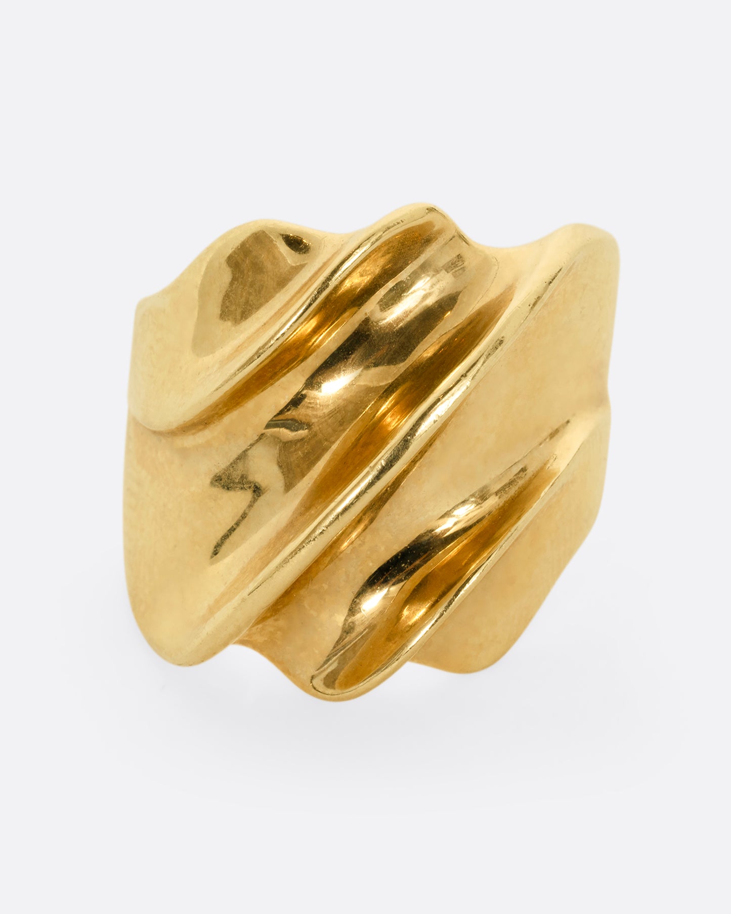 A chunky yellow gold wave ring. Shown from the front.