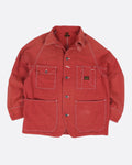 A red canvas chore coat with four front pockets. View from the front.