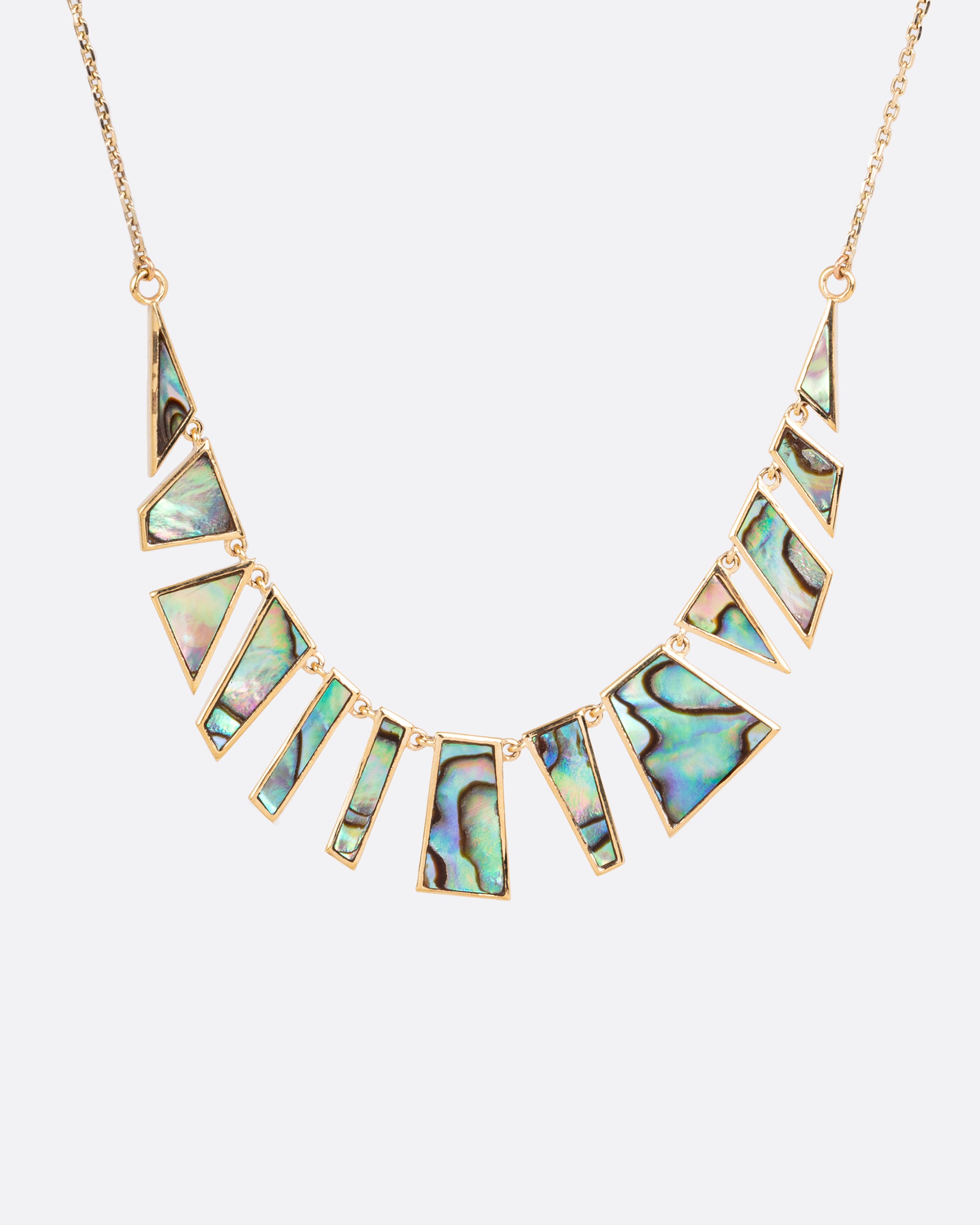 Geometric slices of abalone fit together in this mosaic necklace.