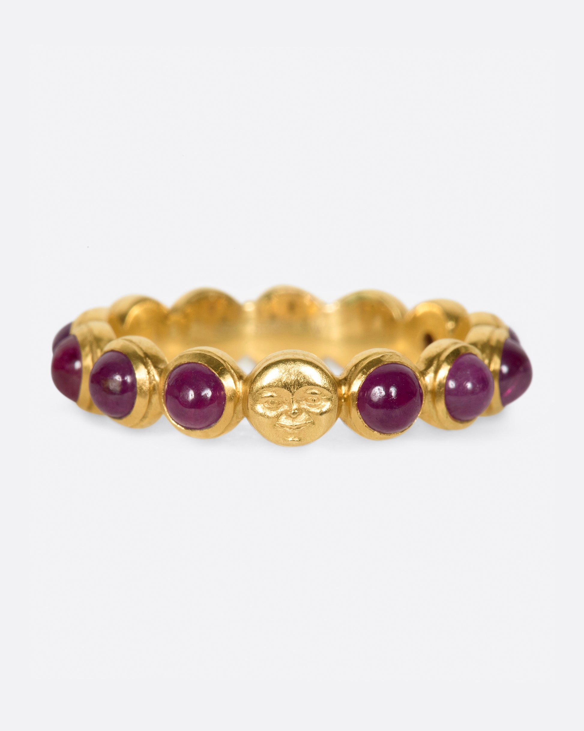 An eternity band of ruby cabochons with one hidden moonface.