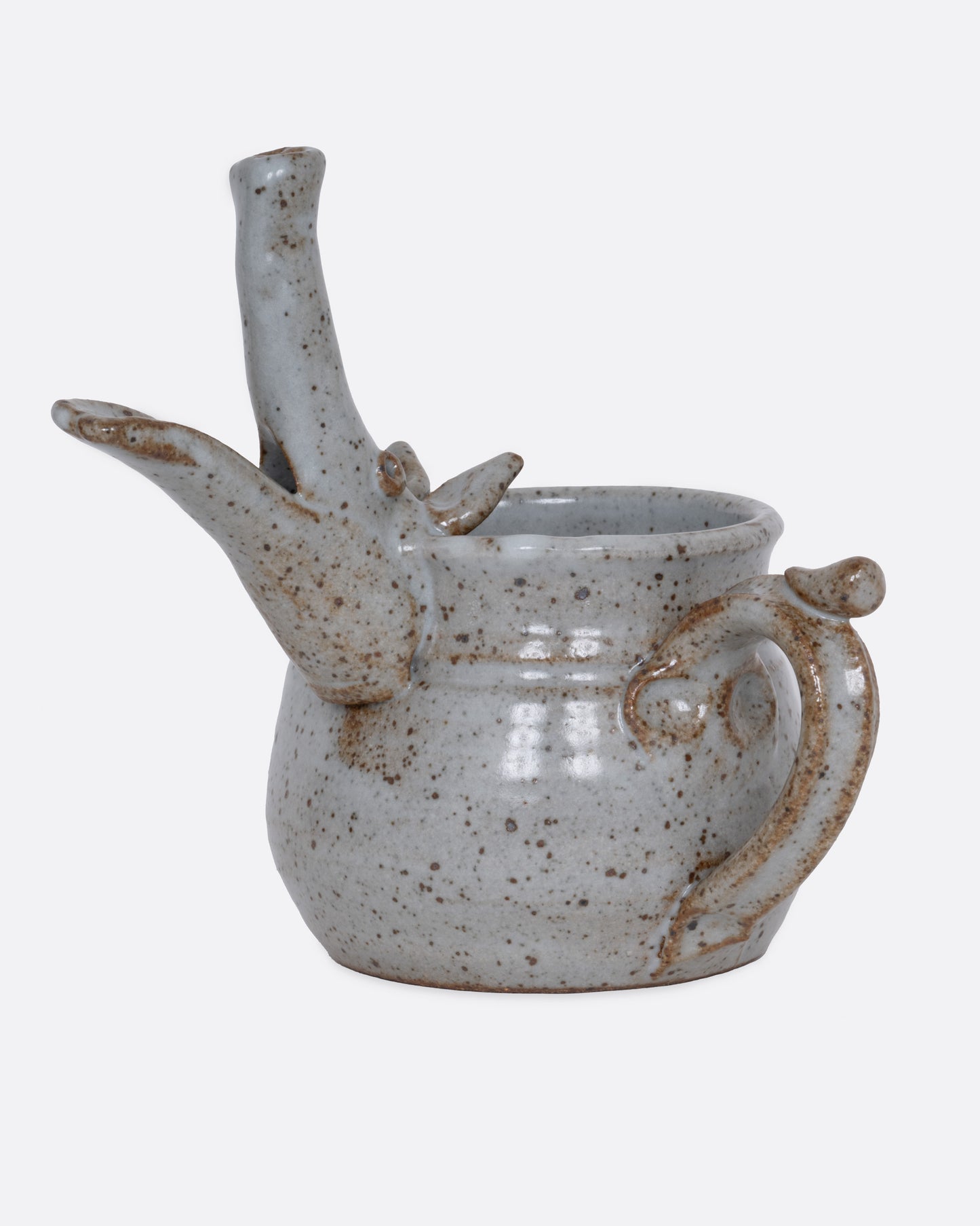 An aardvark mug with a long snout and open mouth spout. Shown from the side.
