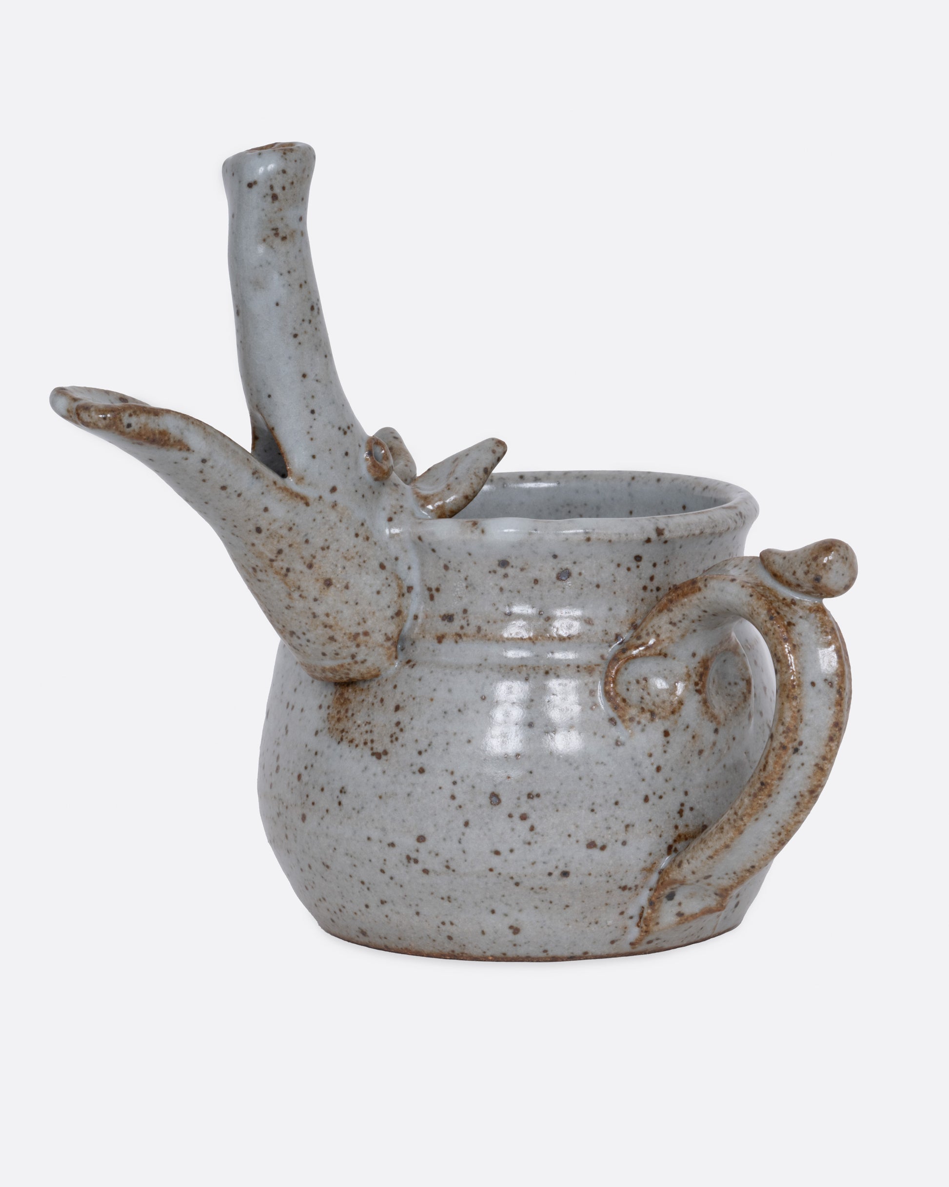 An aardvark mug with a long snout and open mouth spout. Shown from the side.