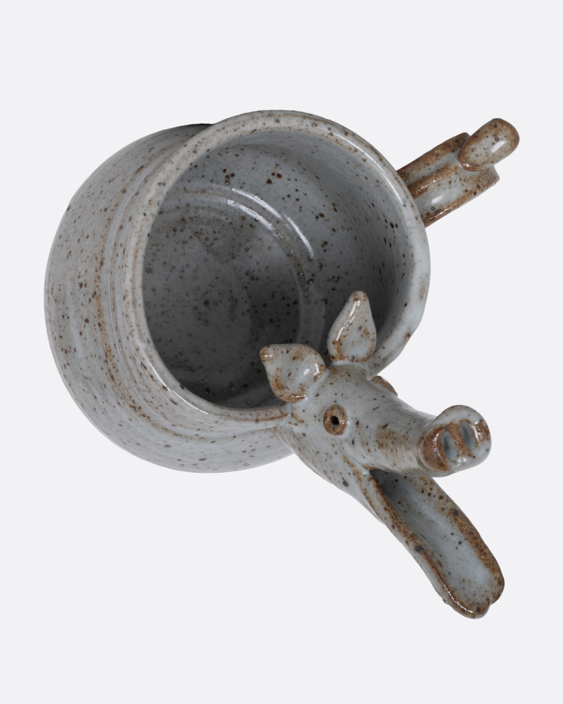 An aardvark mug with a long snout and open mouth spout. Shown from the top.