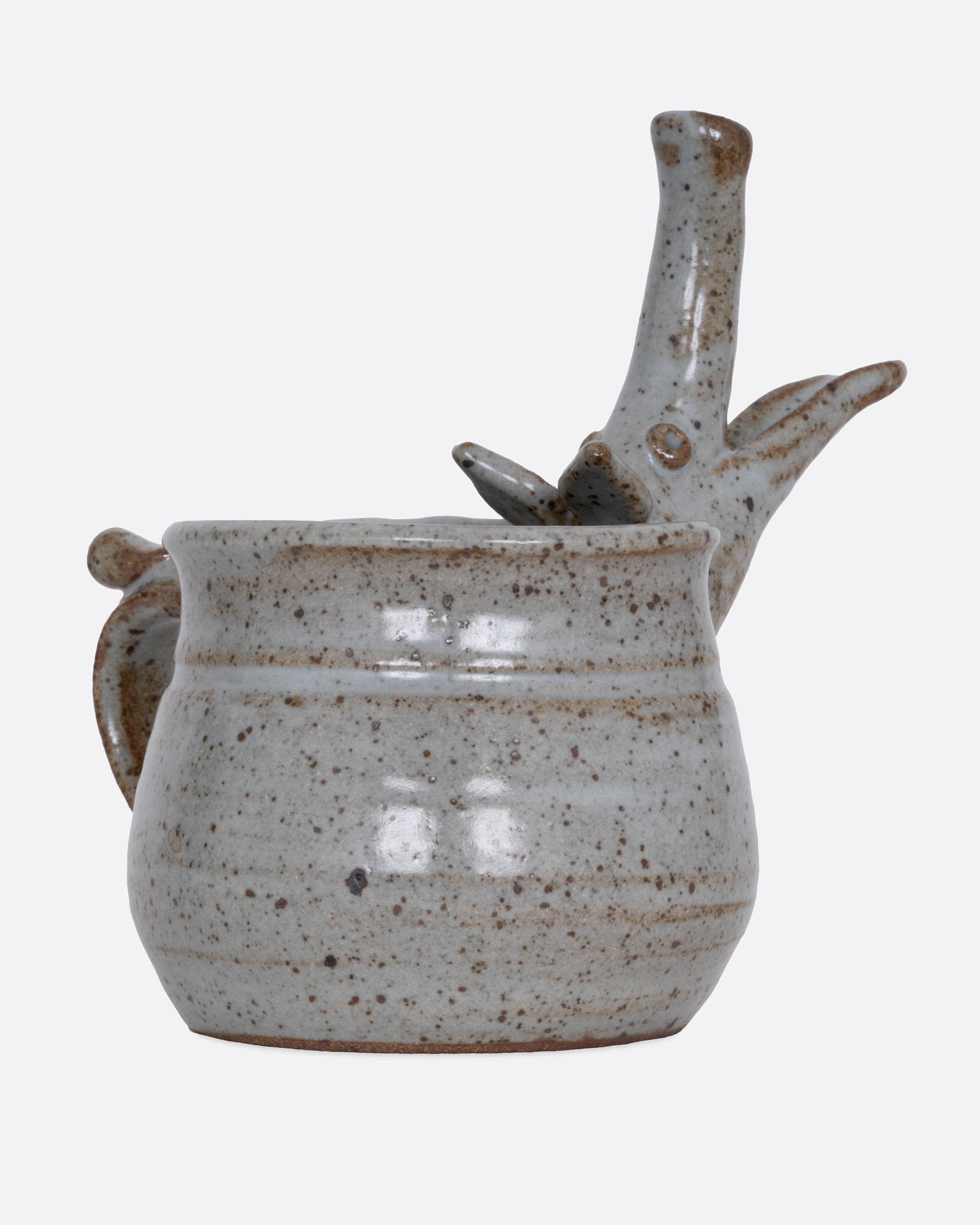 An aardvark mug with a long snout and open mouth spout. Shown from the side.