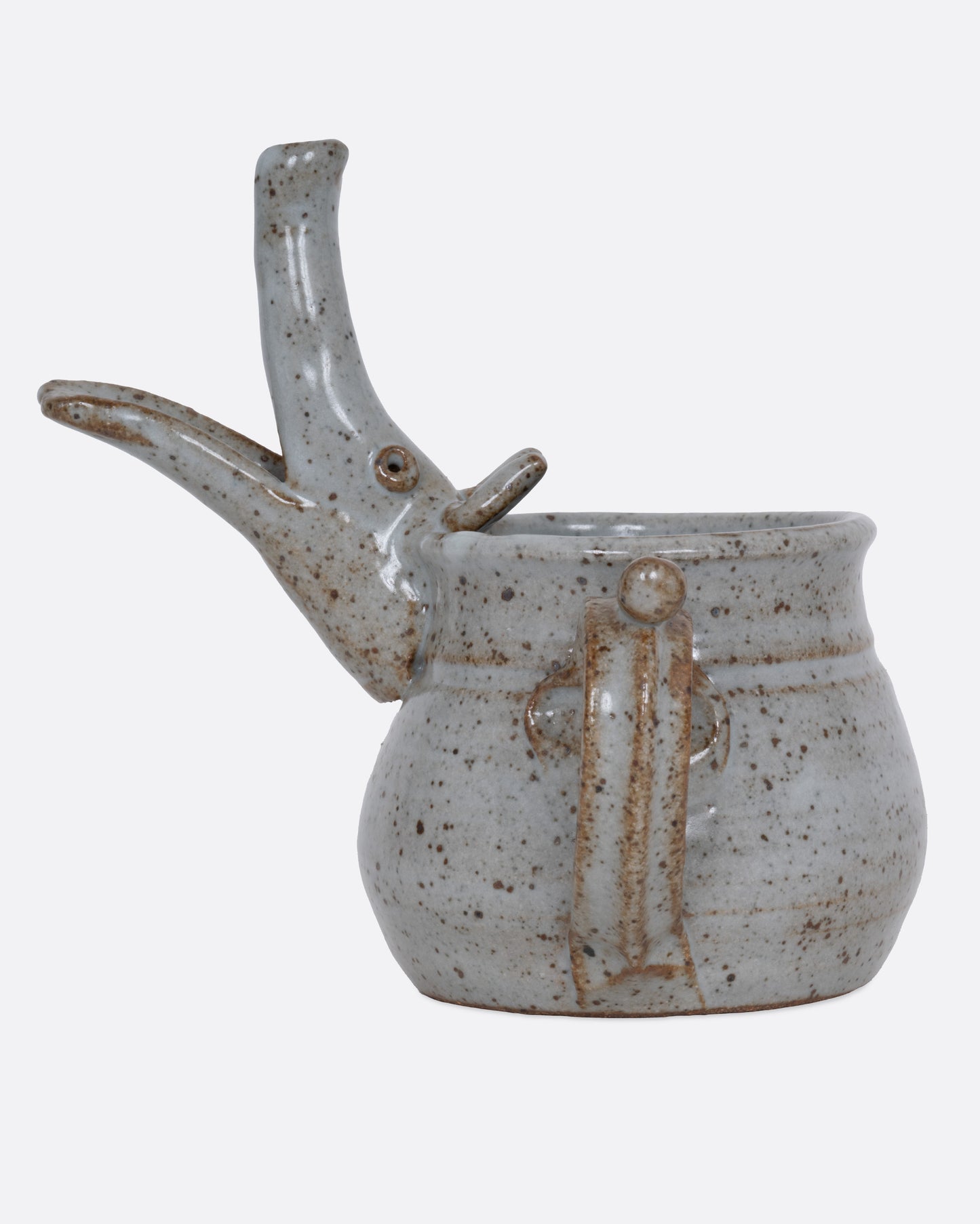 An aardvark mug with a long snout and open mouth spout. Shown from the side.