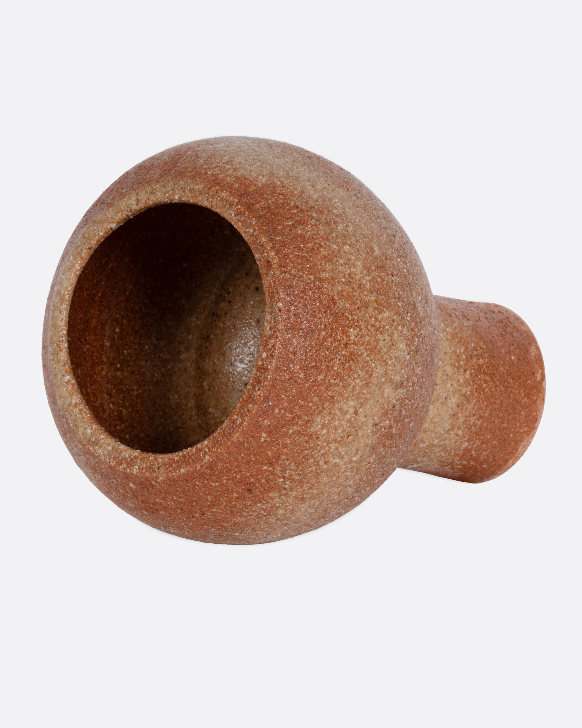 A terracotta planter with a narrow base and spherical top. Shown lying on its side from the side.